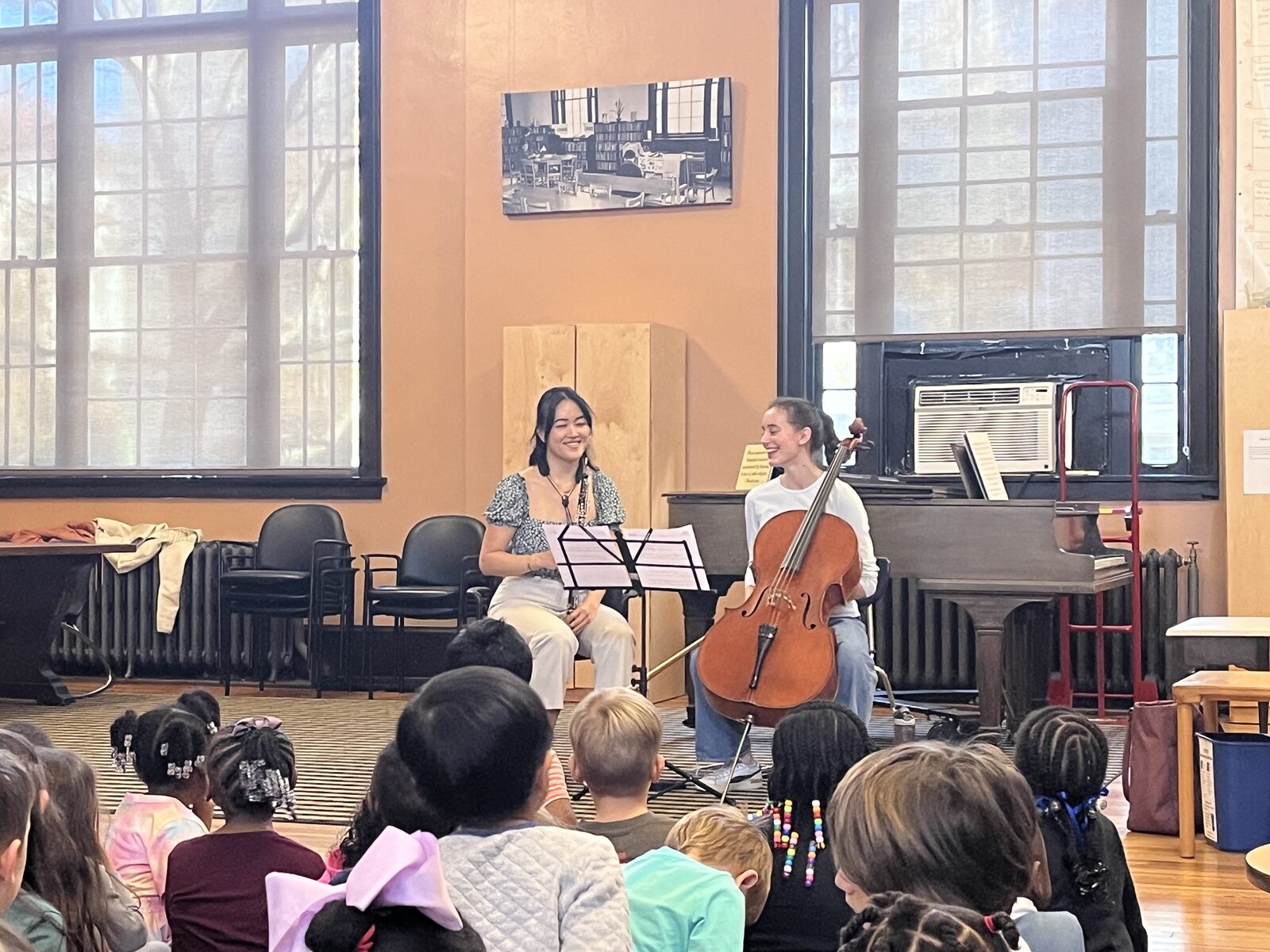 Martha performing for schoolchildren alongside an oboist
